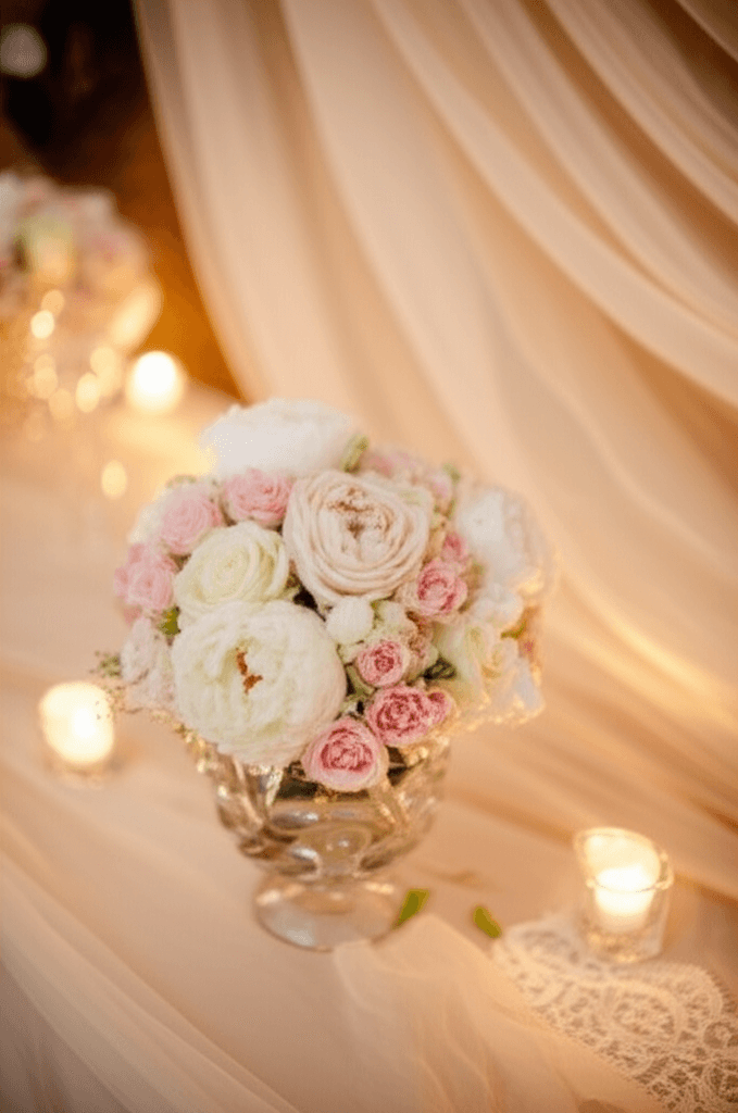 Romantic wedding style with soft blush roses and warm candlelight